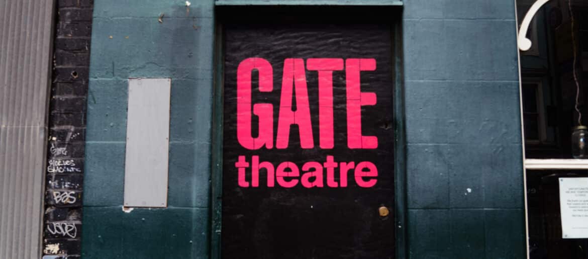 Exterior of former Gate Theatre home in Notting Hill showing a black door on the side of a pub with Gate Theatre branding