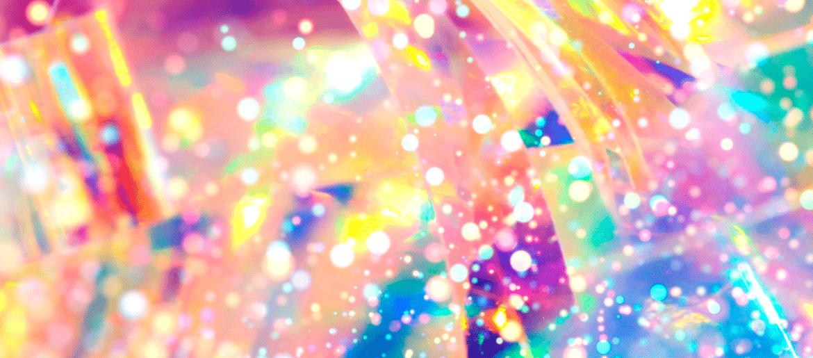 The background is bright, multi-coloured and full of sparkles